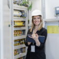 A portrait of female chief engineer in modern industrial factory using tablet.